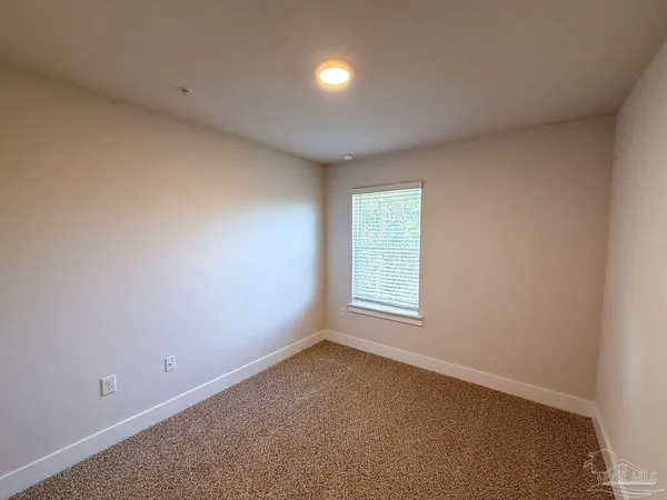 an empty room with a empty space and windows