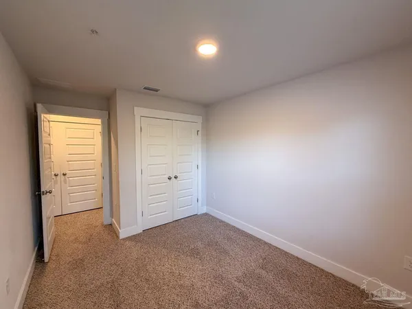 an empty room with closet area