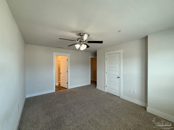 a view of a livingroom with a chandelier fan