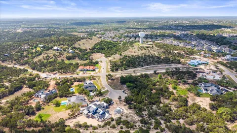 an aerial view of residential building with yard