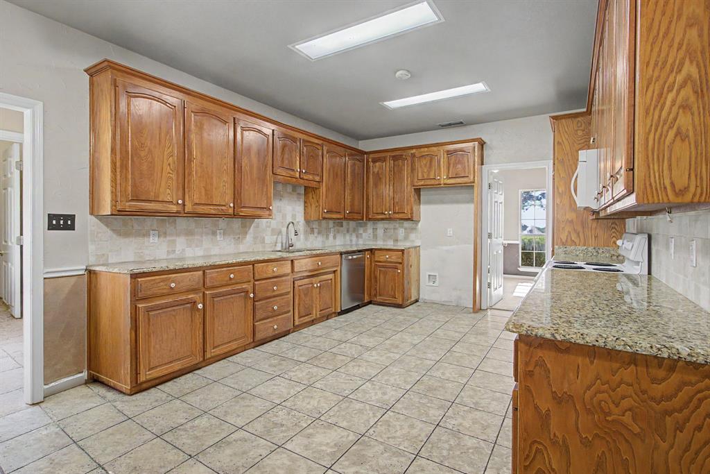 483 Christy Kay Lane Rhome, TX 76078 - Photo 15 of 40 a kitchen with a sink window and cabinets