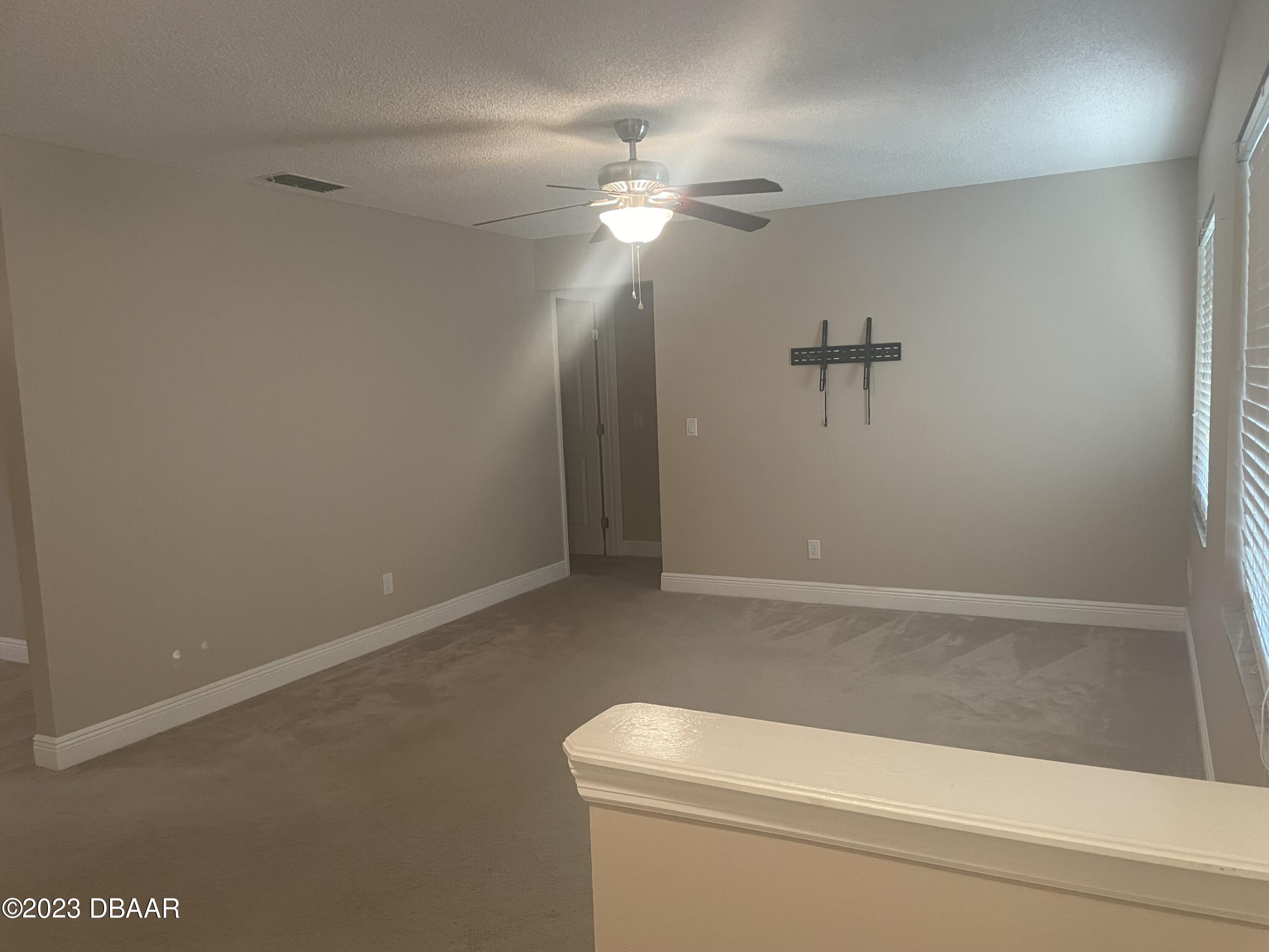 261 Manhattan Way Port Orange, FL 32129 - Photo 8 of 18 a bathroom with a light fixture and a fan