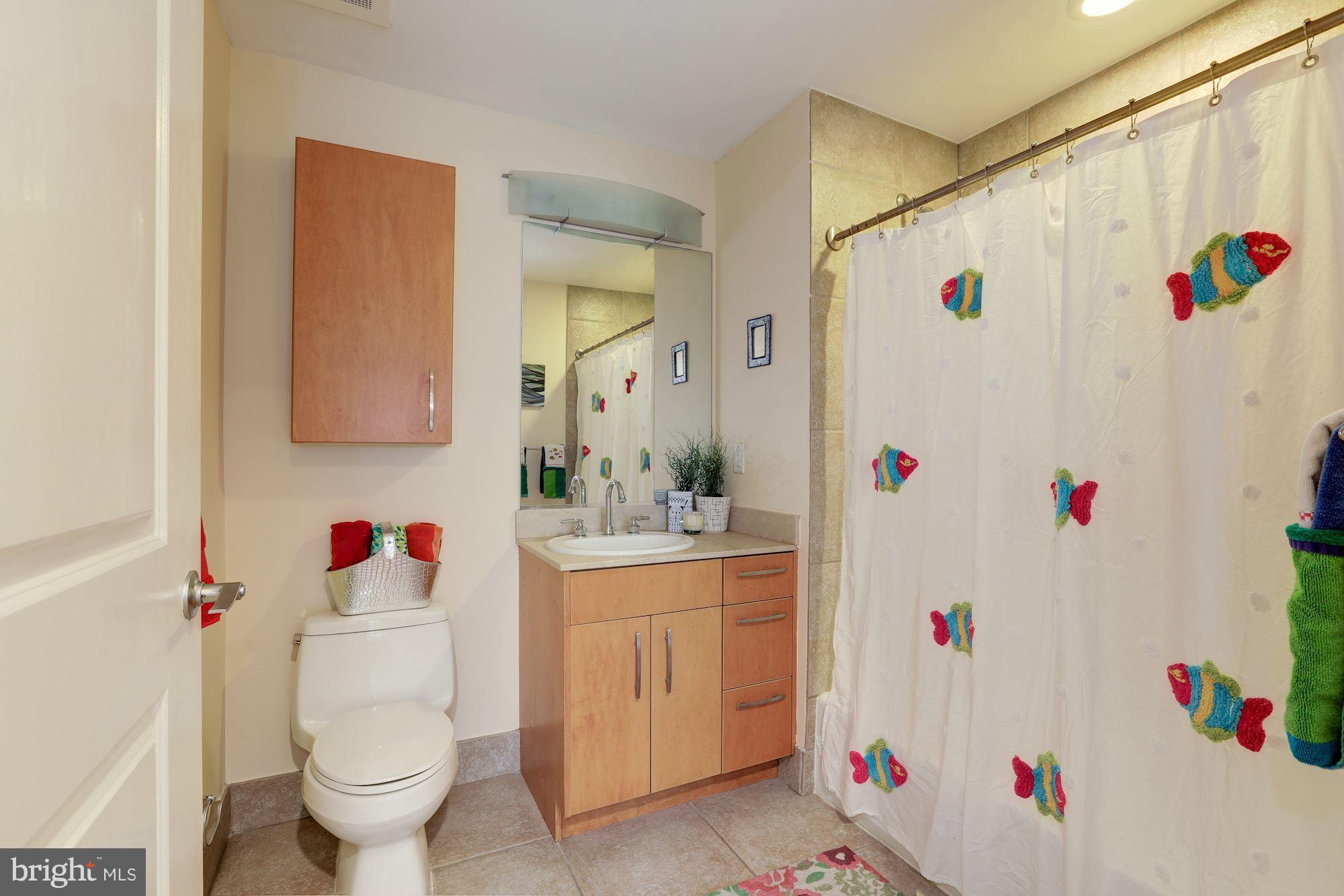 1444 Church Street Northwest, Unit 206 Washington, DC 20005 - Photo 14 of 22 a white sink sitting next to a white toilet and a sink