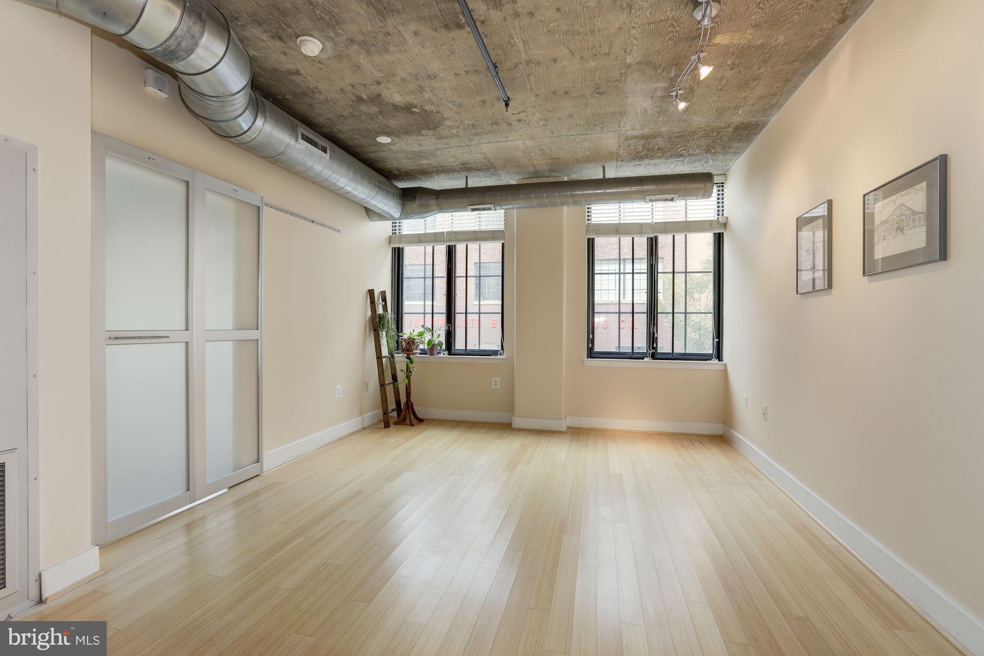 1444 Church Street Northwest, Unit 206 Washington, DC 20005 - Photo 8 of 22 a view of an empty room with a window and wooden floor