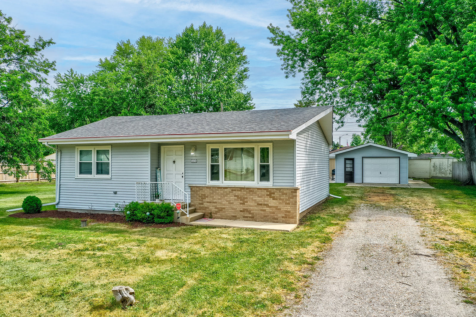 a front view of a house with a garden