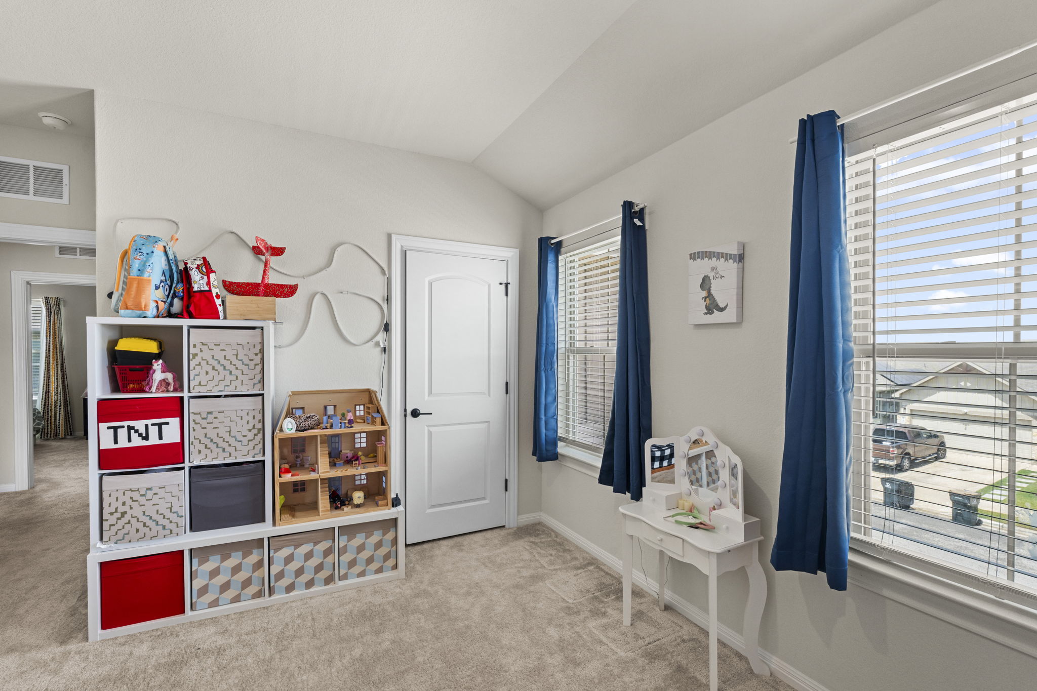 548 Purple Heart Drive Buda, TX 78610 - Photo 22 of 35 A well-lit bedroom features plush carpeting and two sun-filled windows.