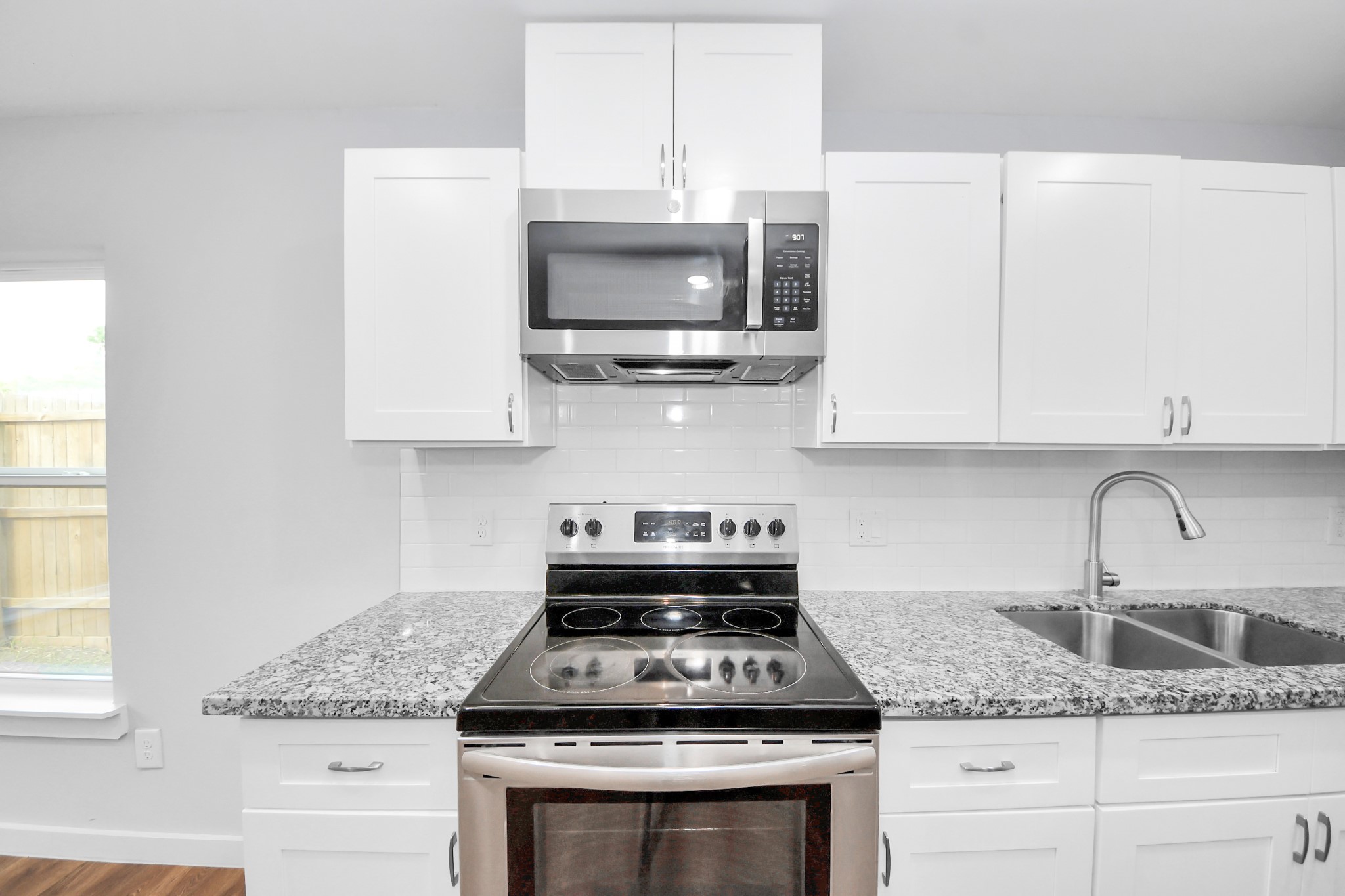 6609 Bacher Street, Unit A Houston, TX 77028 - Photo 12 of 33 a kitchen with granite countertop a sink stainless steel appliances and cabinets