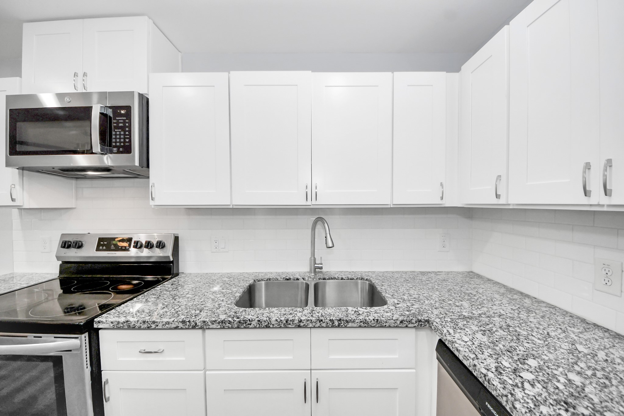6609 Bacher Street, Unit A Houston, TX 77028 - Photo 13 of 33 a kitchen with granite countertop white cabinets and a sink