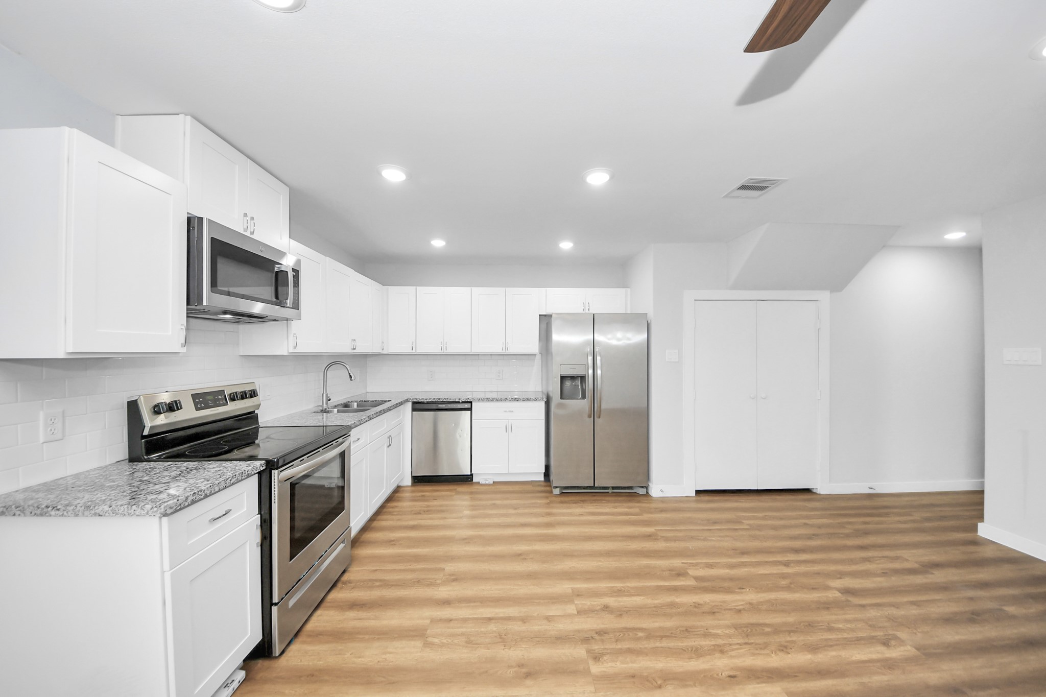 6609 Bacher Street, Unit A Houston, TX 77028 - Photo 14 of 33 a large kitchen with stainless steel appliances granite countertop a stove a sink and a refrigerator