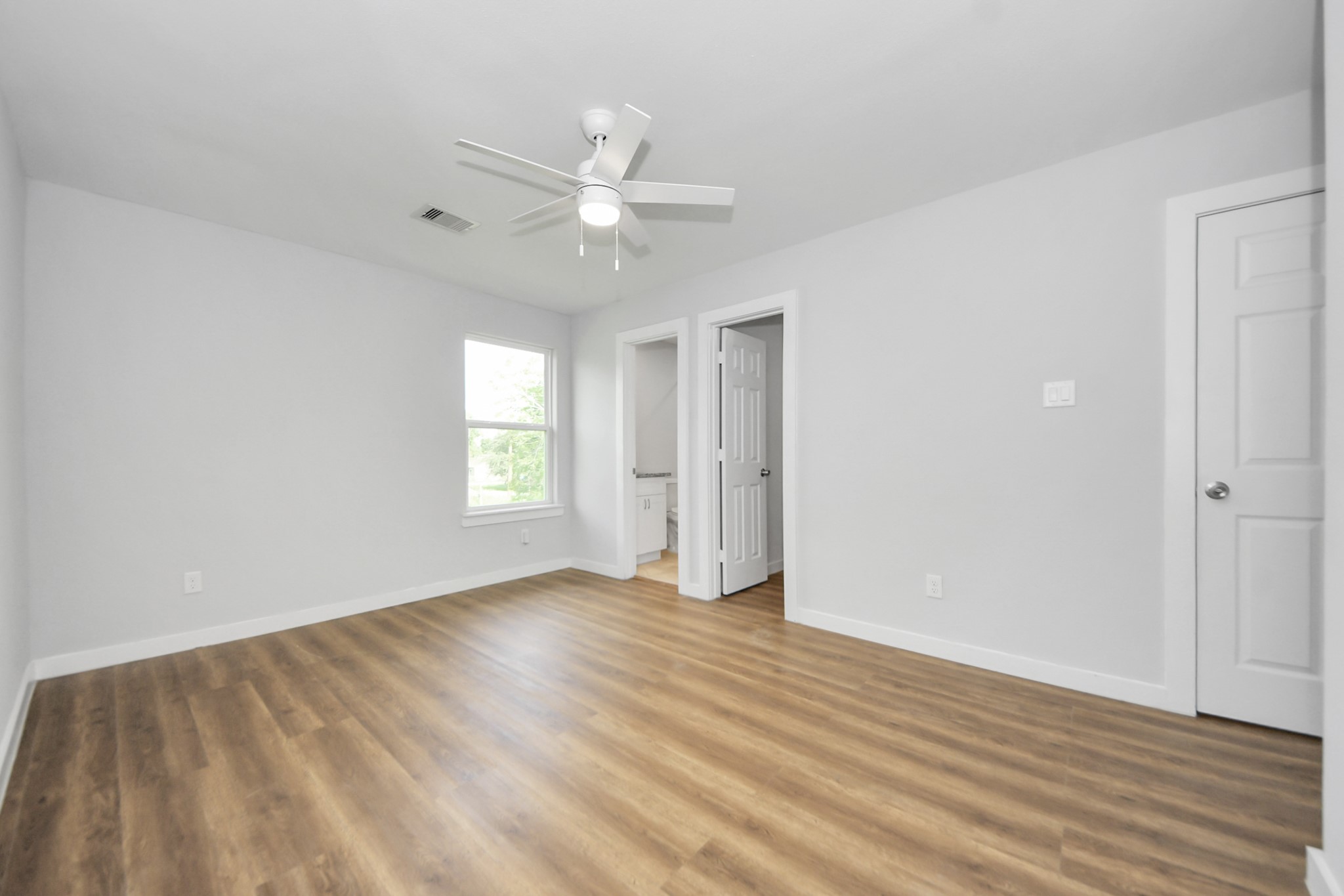 6609 Bacher Street, Unit A Houston, TX 77028 - Photo 27 of 33 an empty room with wooden floor ceiling fan and windows