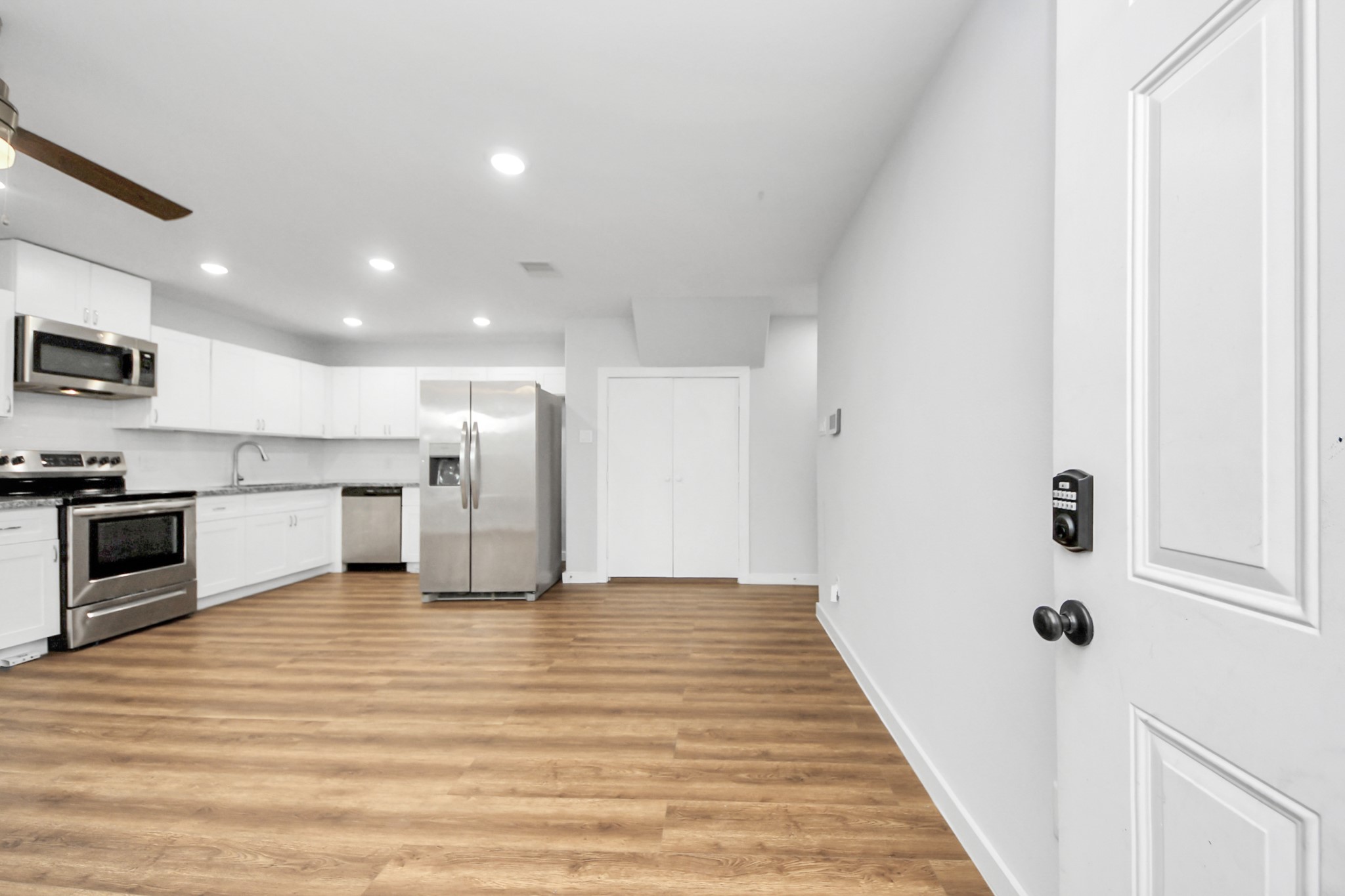 6609 Bacher Street, Unit A Houston, TX 77028 - Photo 6 of 33 a view of a kitchen with a sink a microwave and cabinets