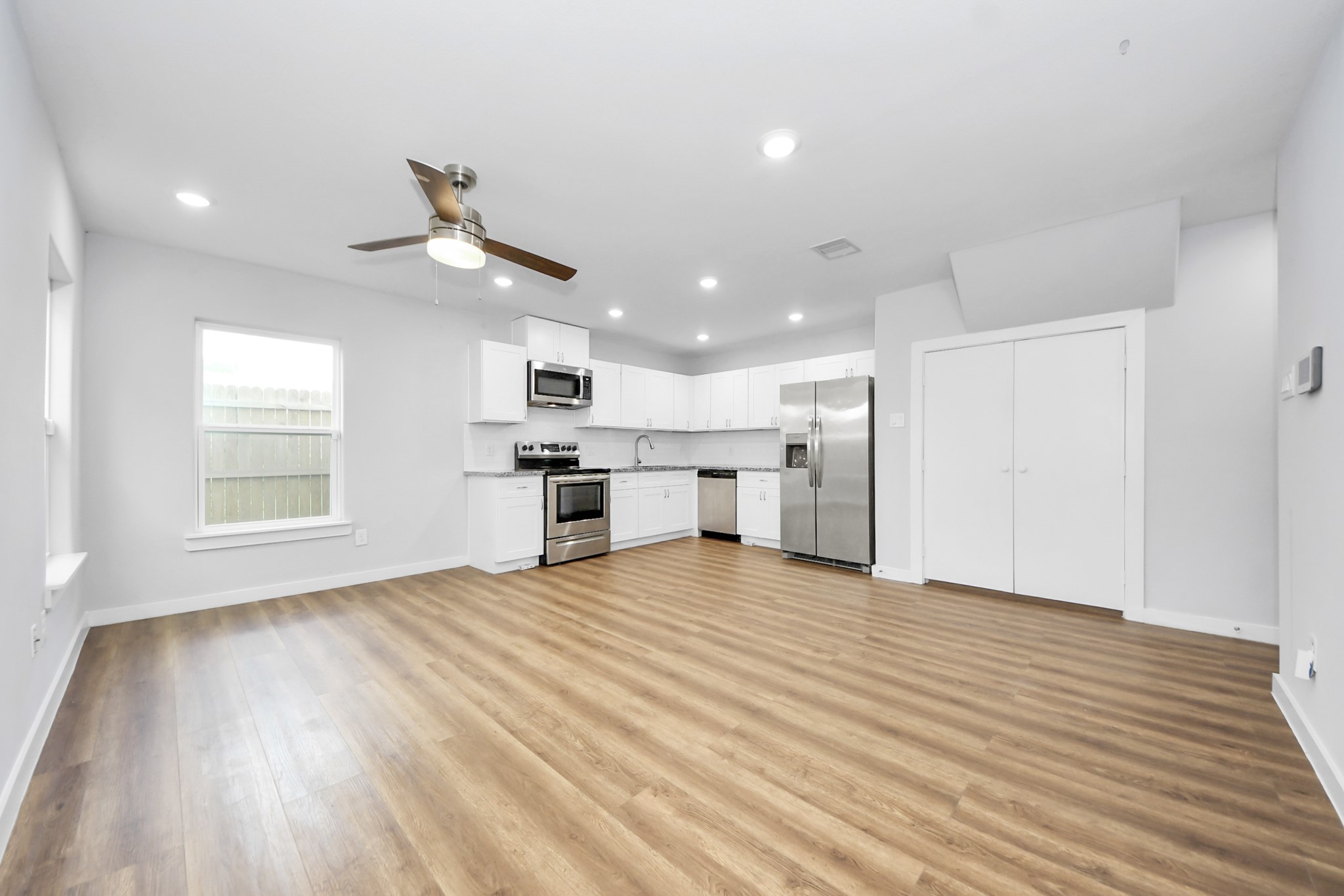 6609 Bacher Street, Unit A Houston, TX 77028 - Photo 7 of 33 a view of an empty room with a window and wooden floor