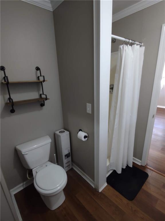 1 Westlyn Drive Rome, GA 30165 - Photo 18 of 26 a white toilet sitting next to a shower curtain