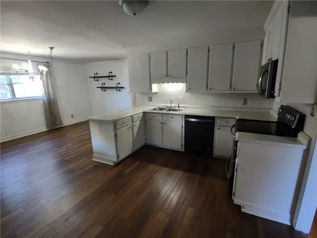 a kitchen with a refrigerator and a stove top oven