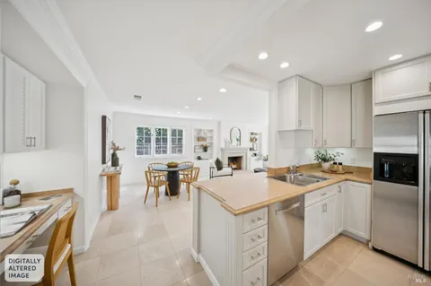 a kitchen that has a lot of cabinets in it and appliances
