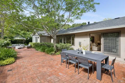 a backyard of a house with table and chairs