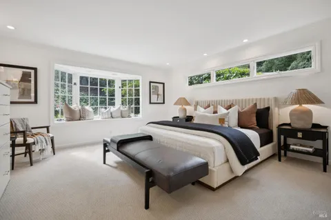 a spacious bedroom with a bed and a couch