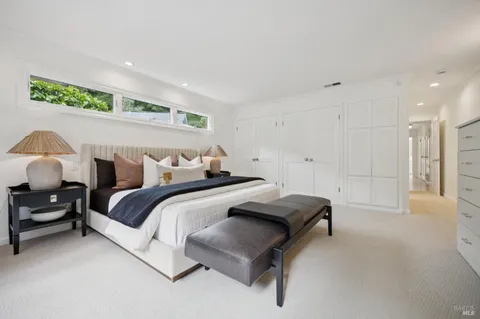 a bedroom with a bed and a chair