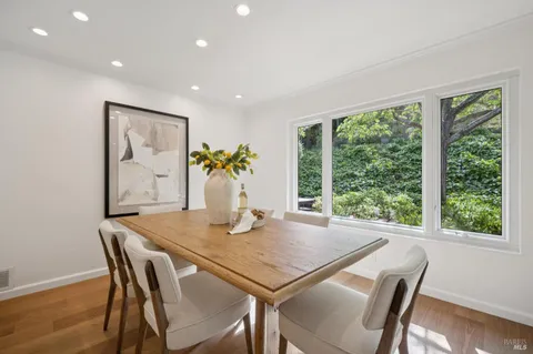 a view of a dining room with furniture window and wooden floor