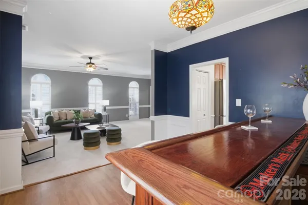 a living room with furniture and a chandelier