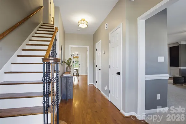 a view of entryway and hall with wooden floor