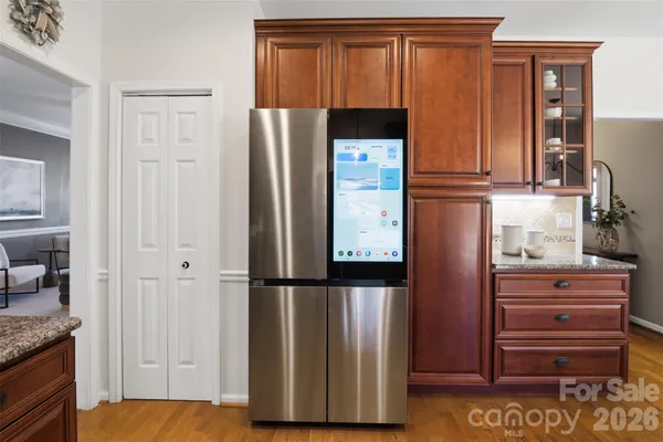 a kitchen with a refrigerator and cabinets