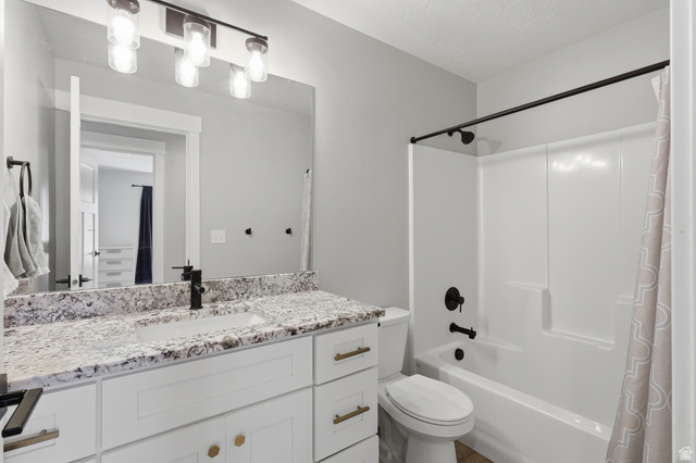 625 East 100 South Ephraim, UT 84627 - Photo 7 of 26 Bathroom featuring a white vanity with gold-toned hardware, a stone-finish countertop, an undermount sink, and a black-finish faucet