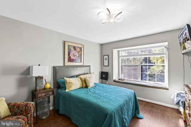 a bedroom with a large bed and a window