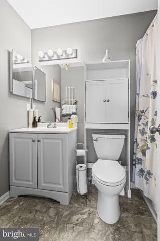 a bathroom with a toilet sink and mirror
