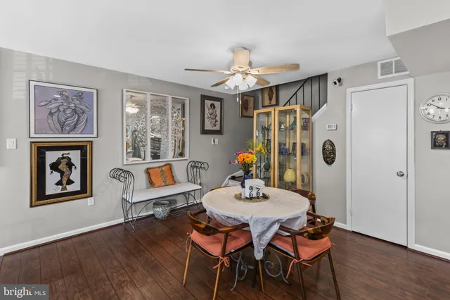 a view of a dining room with furniture wooden floor and chandelier