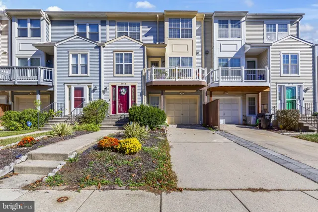 front view of a brick house with a small yard