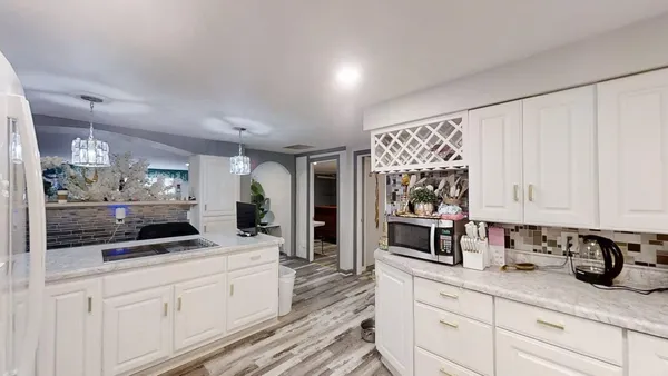 a living room with furniture and a chandelier