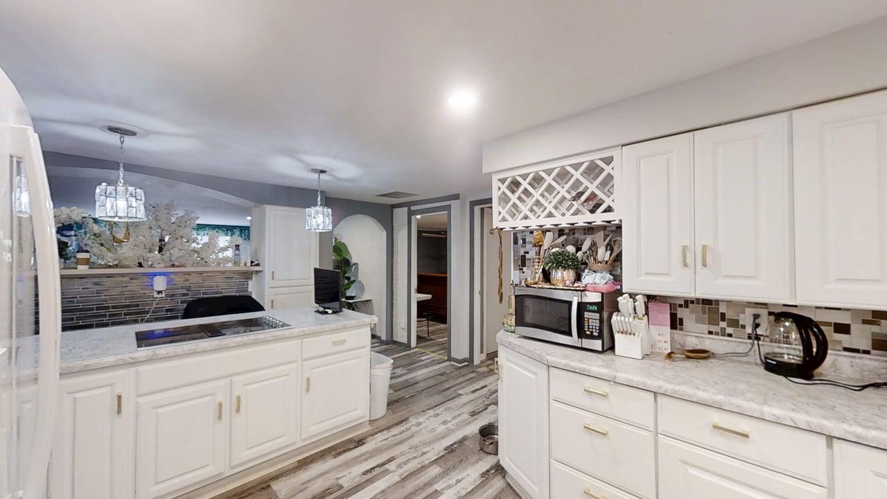 23 Greenridge Drive Decatur, IL 62526 - Photo 12 of 42 a kitchen with granite countertop white cabinets and stainless steel appliances