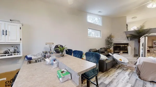 a living room with furniture and a chandelier