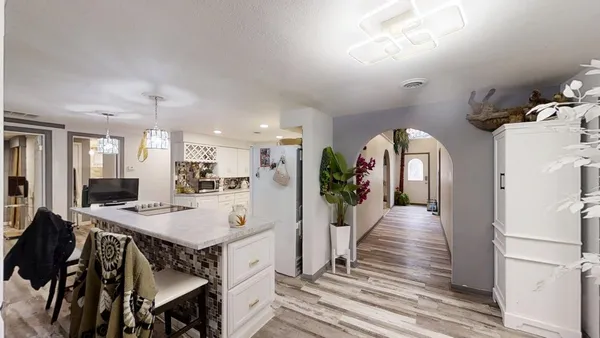 a kitchen with kitchen island granite countertop lots of counter top space and stainless steel appliances