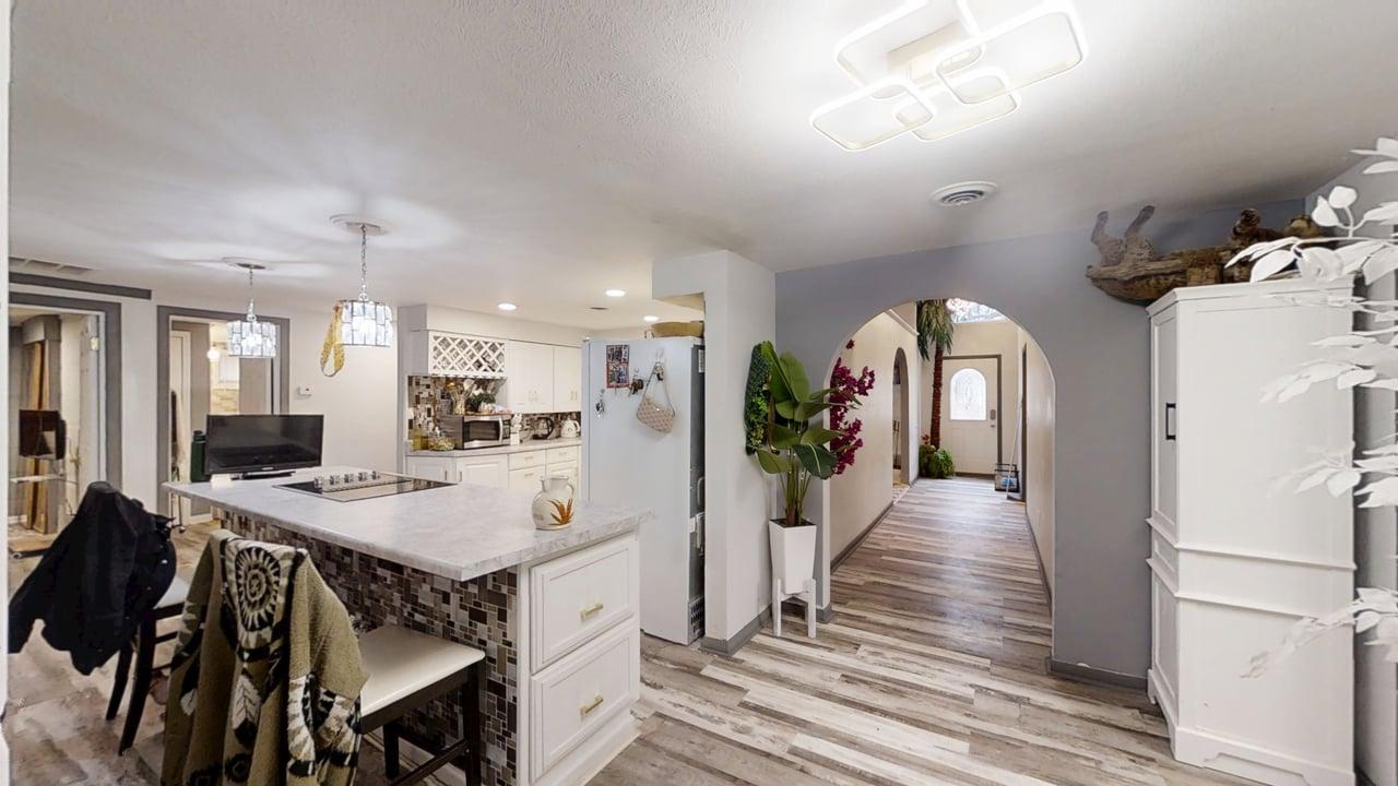 23 Greenridge Drive Decatur, IL 62526 - Photo 7 of 42 a view of a hallway with dining room and wooden floor