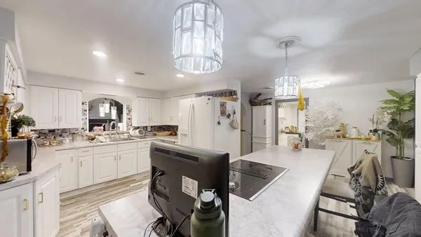 a kitchen with granite countertop a refrigerator and a stove