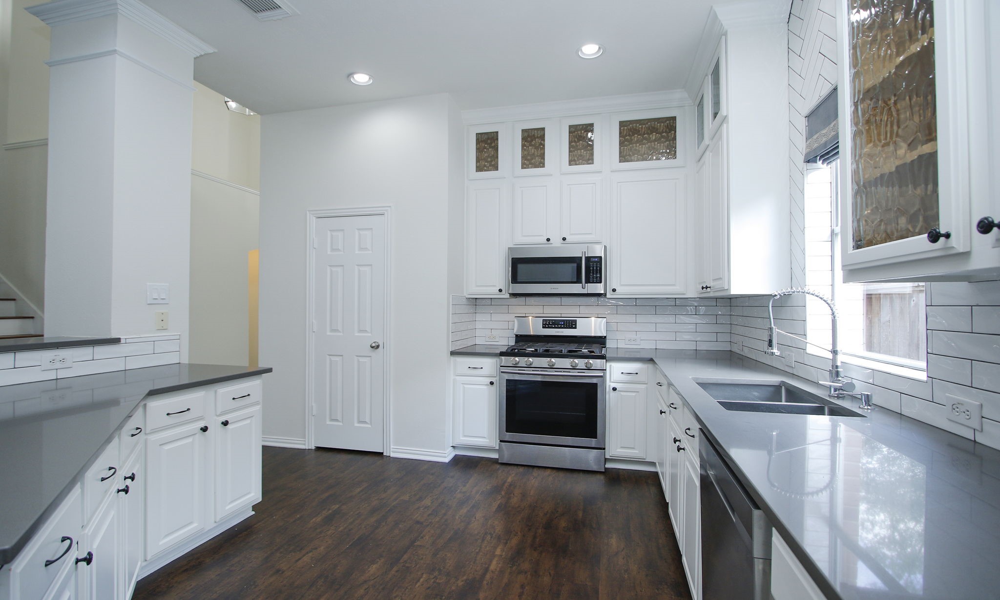 1210 Berwick Manor Court Spring, TX 77379 - Photo 24 of 50 a kitchen with stainless steel appliances kitchen island granite countertop a stove a sink and a refrigerator