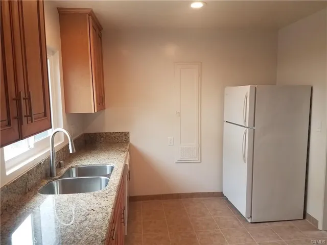 a kitchen with a refrigerator and a sink