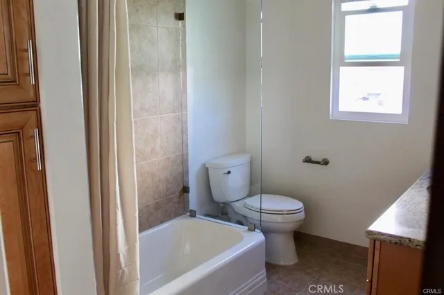 a white toilet sitting next to a bathroom sink