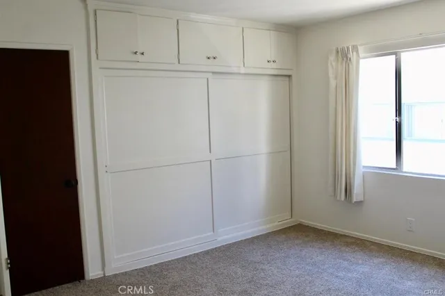 a view of cabinets and refrigerator in kitchen