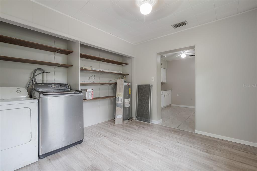10411 North Woodmere Road Tampa, FL 33617 - Photo 19 of 29 a view of a kitchen with a sink and a refrigerator