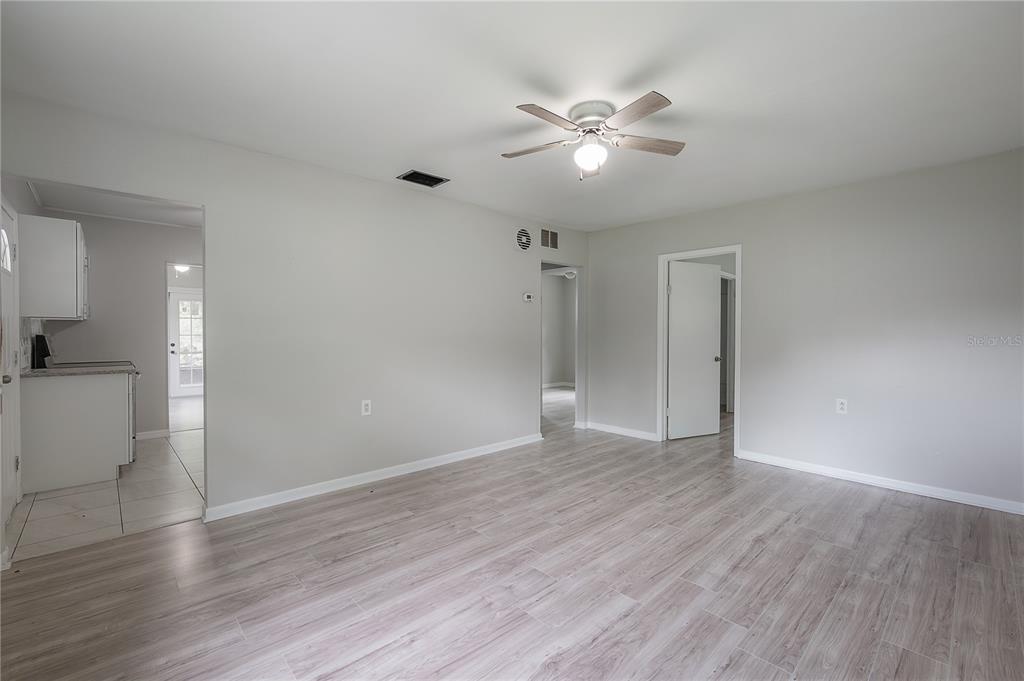 10411 North Woodmere Road Tampa, FL 33617 - Photo 7 of 29 a view of an empty room with wooden floor