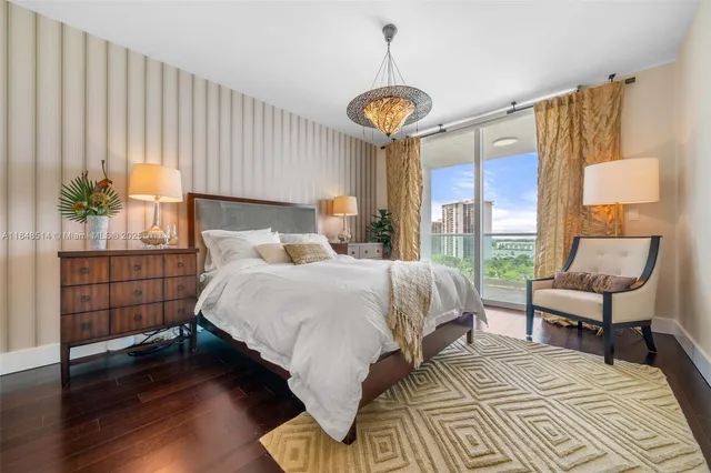 a bedroom with a bed and a chandelier