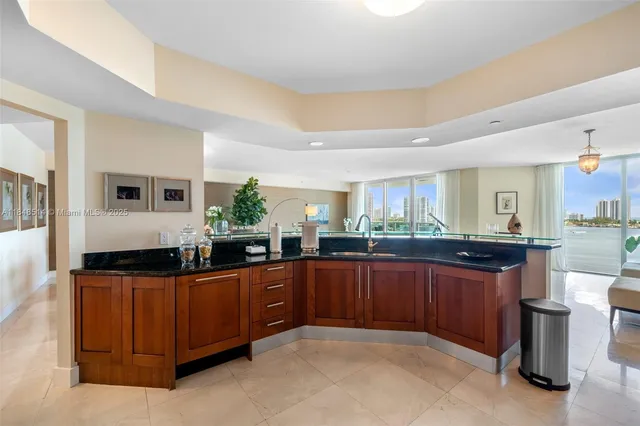 a kitchen with granite countertop a sink and cabinets