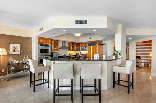 a kitchen with a dining table chairs and large window