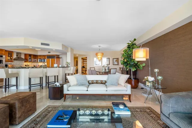 a living room with furniture a rug and a potted plant