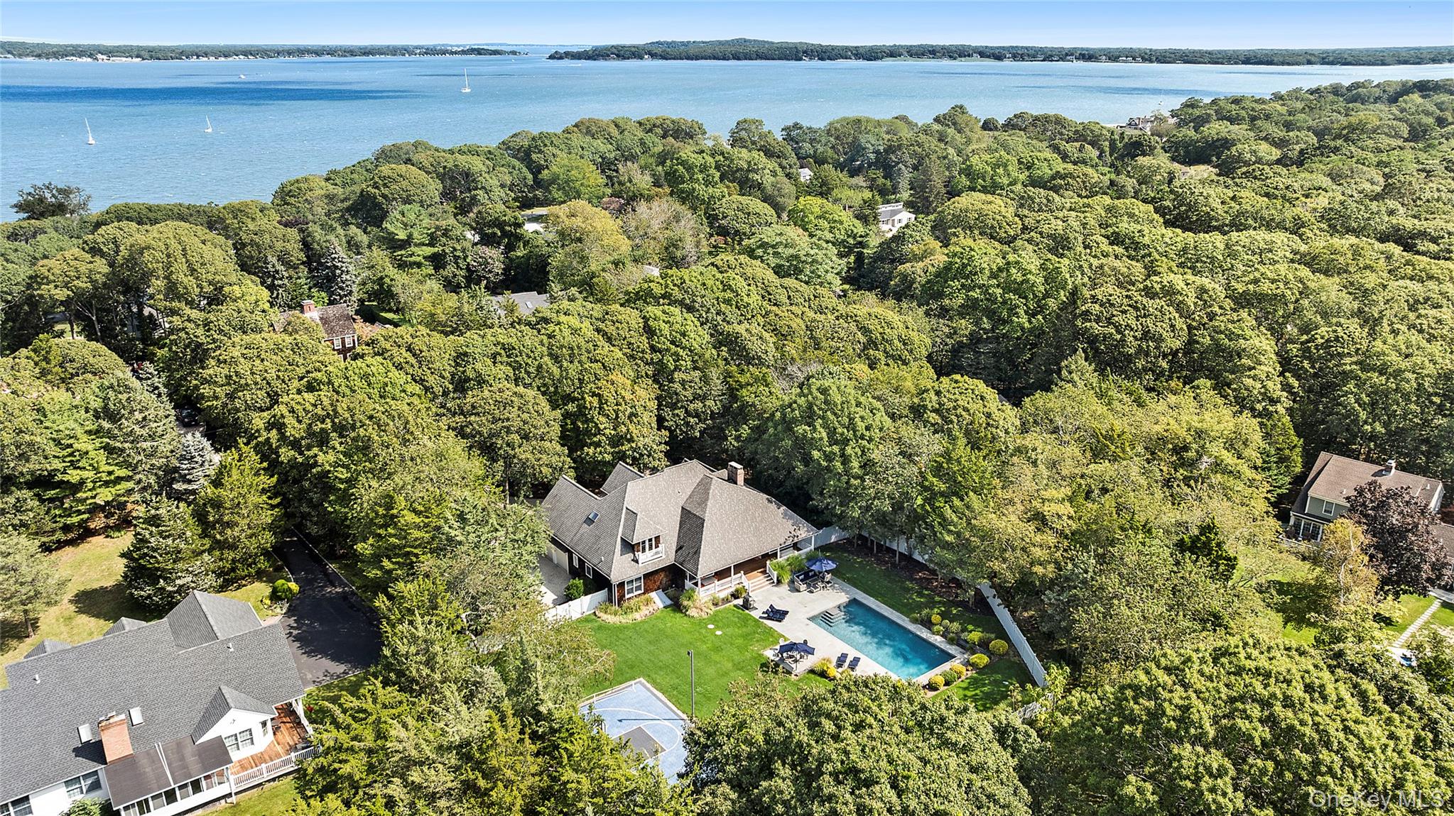 3470 North Bayview Road Southold, NY 11971 - Photo 22 of 25 Aerial view of property and surrounding area featuring a pool area and a nearby body of water