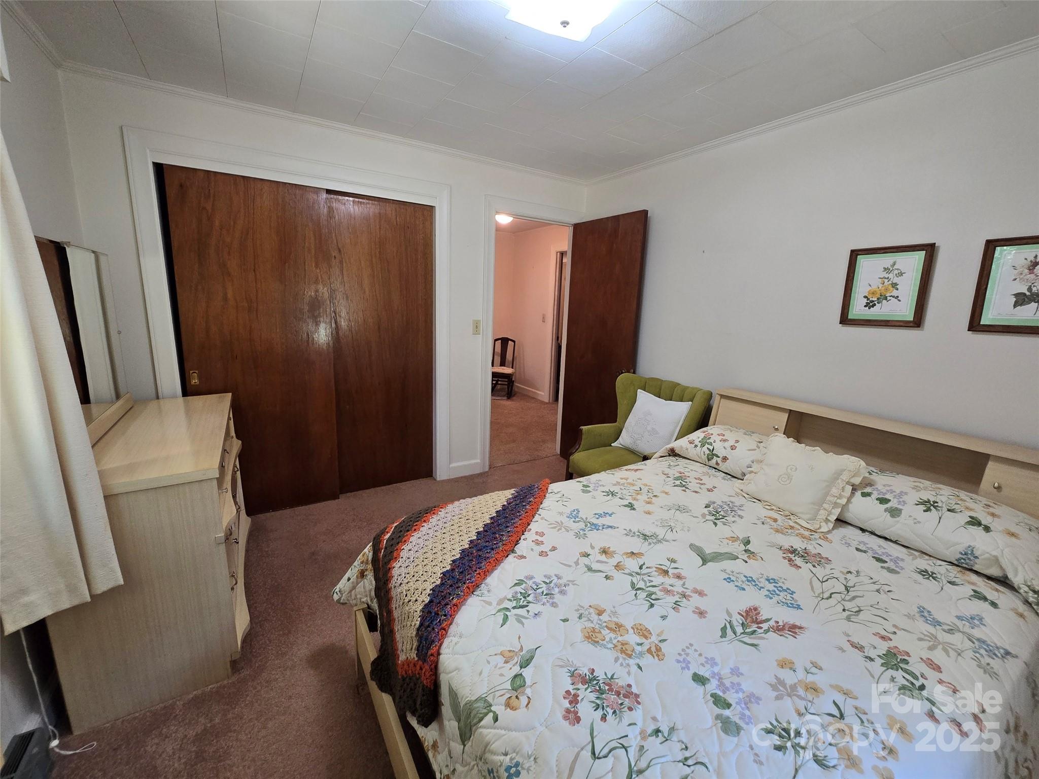 517 Mask Road Mount Gilead, NC 27306 - Photo 17 of 48 a bedroom with a bed and a mirror