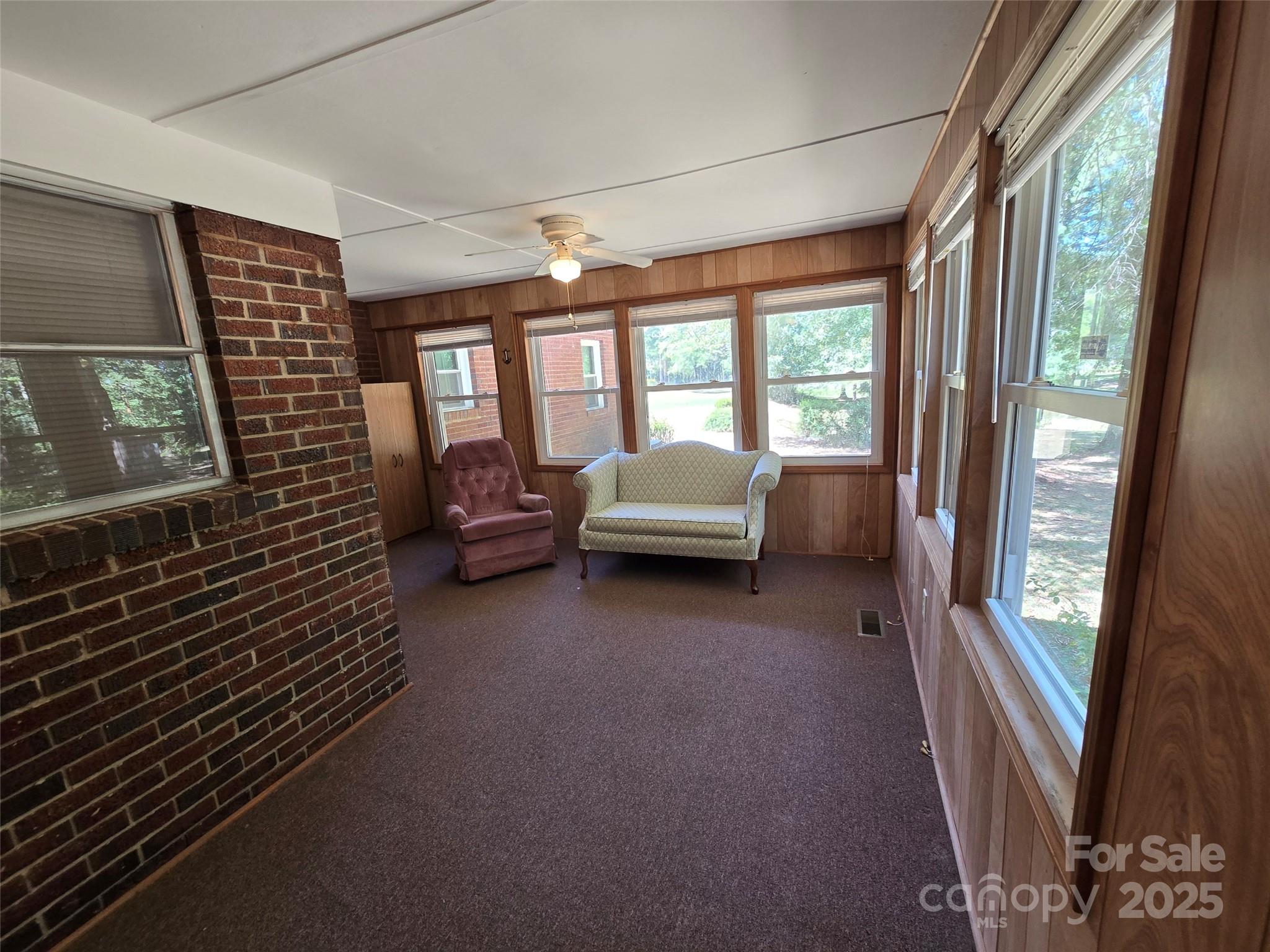 517 Mask Road Mount Gilead, NC 27306 - Photo 27 of 48 a living room with furniture and a floor to ceiling window